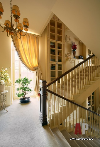 Фото интерьера лестницы трехэтажного загородного дома в классическом стиле